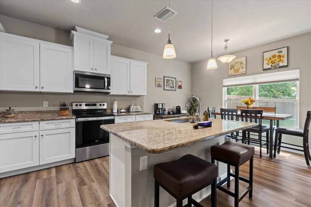 Dining room, Interior, Kitchen, Pendant Lights, Recessed Lighting, Stainless Steel Appliances, Wood Texture Flooring