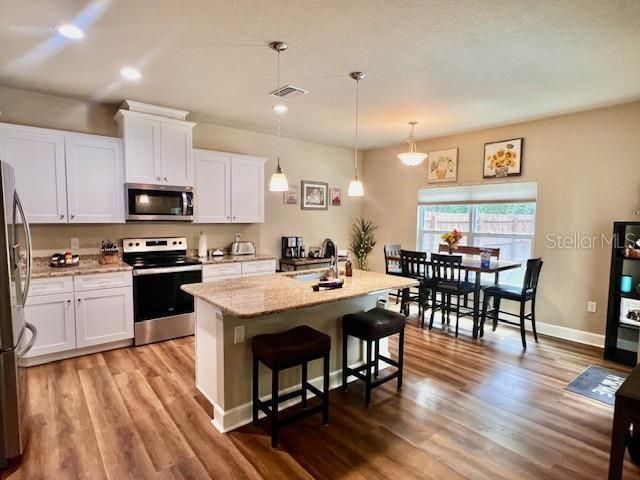 Dining room, Interior, Kitchen, Pendant Lights, Recessed Lighting, Stainless Steel Appliances, Wood Texture Flooring