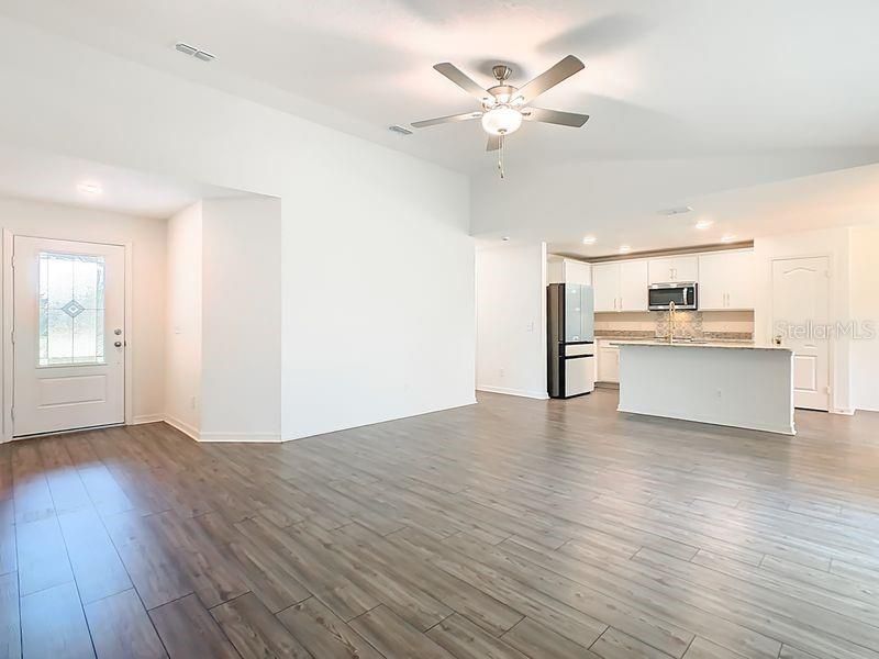Empty room, Interior, Kitchen, Recessed Lighting, Stainless Steel Appliances, Wood Texture Flooring