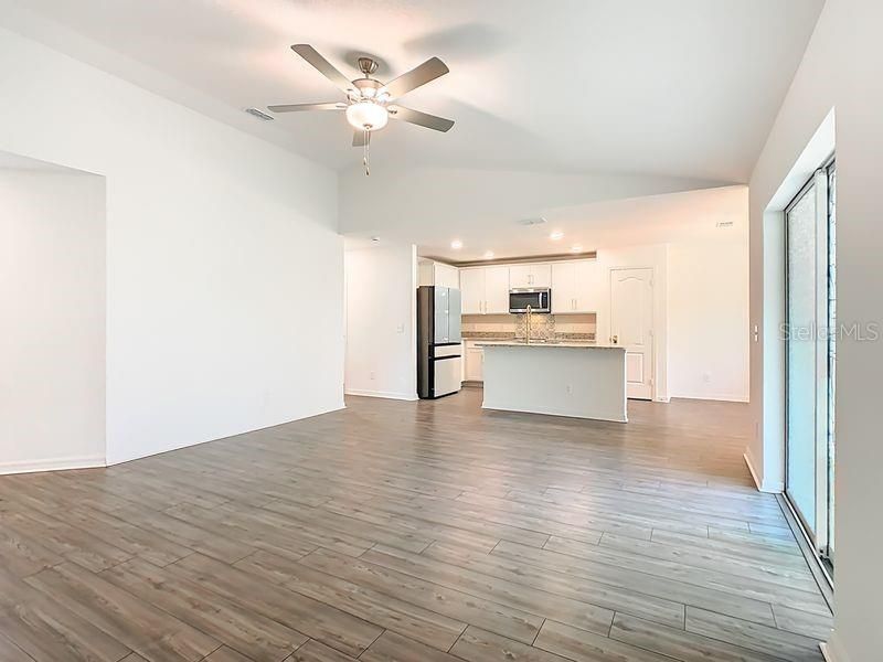 Empty room, Interior, Kitchen, Recessed Lighting, Stainless Steel Appliances, Wood Texture Flooring