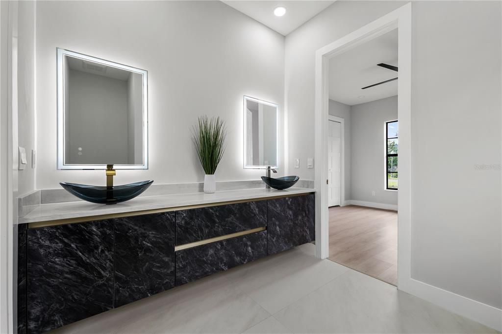Bathroom, Dual Sink Vanities, Interior, Marble Walls, Recessed Lighting, Wood Texture Flooring