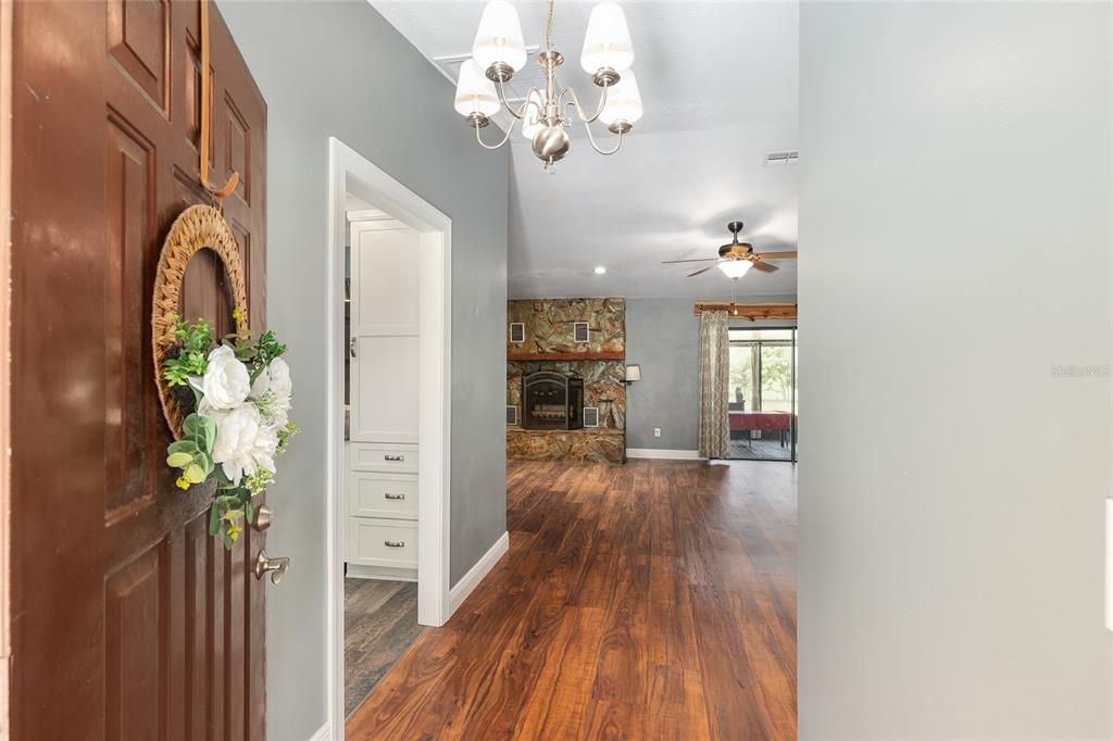 Chandelier, Fireplace, Interior, Recessed Lighting, Stone Walls, Wood Texture Flooring