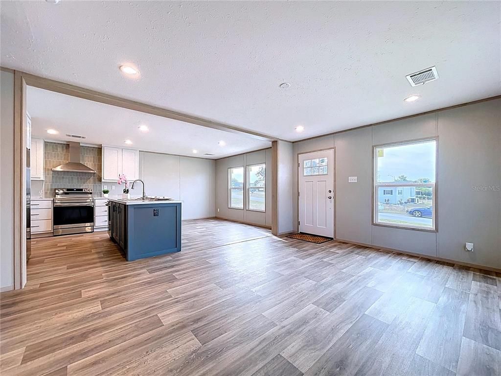 Empty room, Interior, Kitchen, Recessed Lighting, Stainless Steel Appliances, Wood Texture Flooring