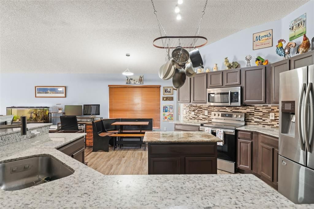 Dining room, Interior, Kitchen, Pendant Lights, Recessed Lighting, Stainless Steel Appliances, Wood Texture Flooring