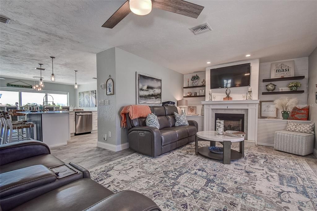 Fireplace, Interior, Kitchen, Living room, Pendant Lights, Recessed Lighting, Stainless Steel Appliances, Wood Texture Flooring