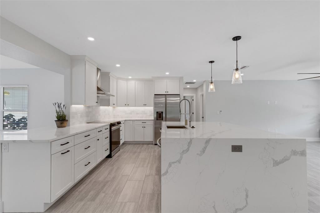 Interior, Kitchen, Marble Walls, Pendant Lights, Recessed Lighting, Stainless Steel Appliances, Wood Texture Flooring