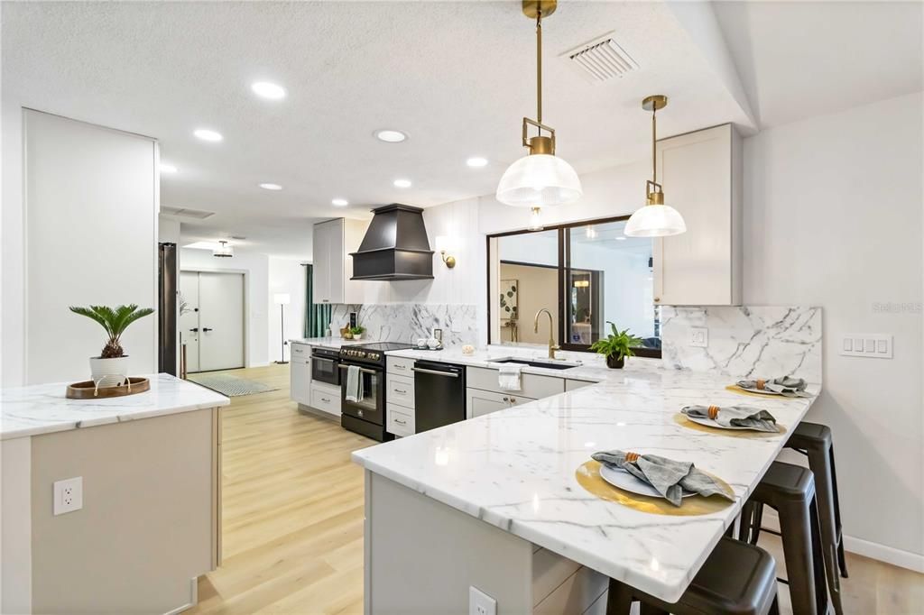 Interior, Kitchen, Marble Walls, Pendant Lights, Recessed Lighting, Stainless Steel Appliances, Wood Texture Flooring