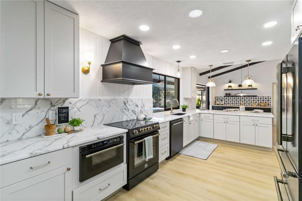 Interior, Kitchen, Marble Walls, Pendant Lights, Recessed Lighting, Stainless Steel Appliances, Wood Texture Flooring