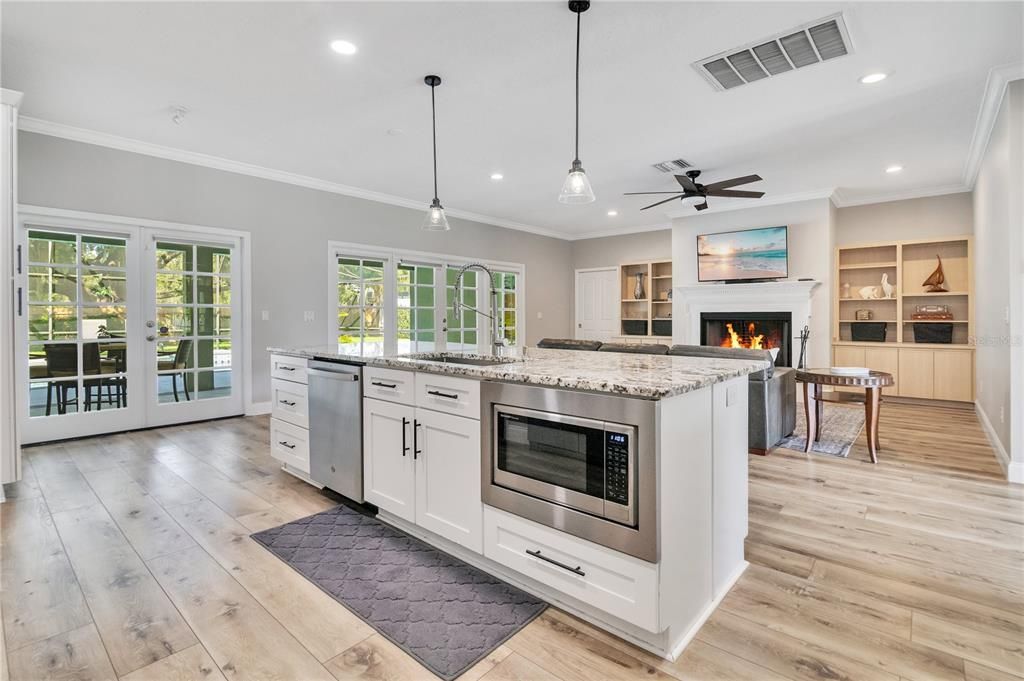 Fireplace, Interior, Kitchen, Pendant Lights, Recessed Lighting, Stainless Steel Appliances, Wood Texture Flooring