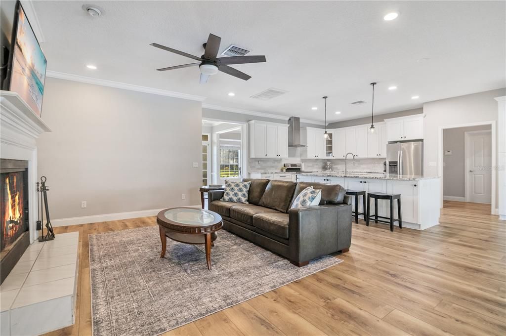 Fireplace, Interior, Kitchen, Living room, Pendant Lights, Recessed Lighting, Stainless Steel Appliances, Wood Texture Flooring