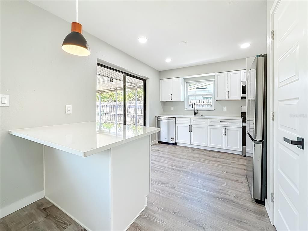 Interior, Kitchen, Pendant Lights, Recessed Lighting, Stainless Steel Appliances, Wood Texture Flooring