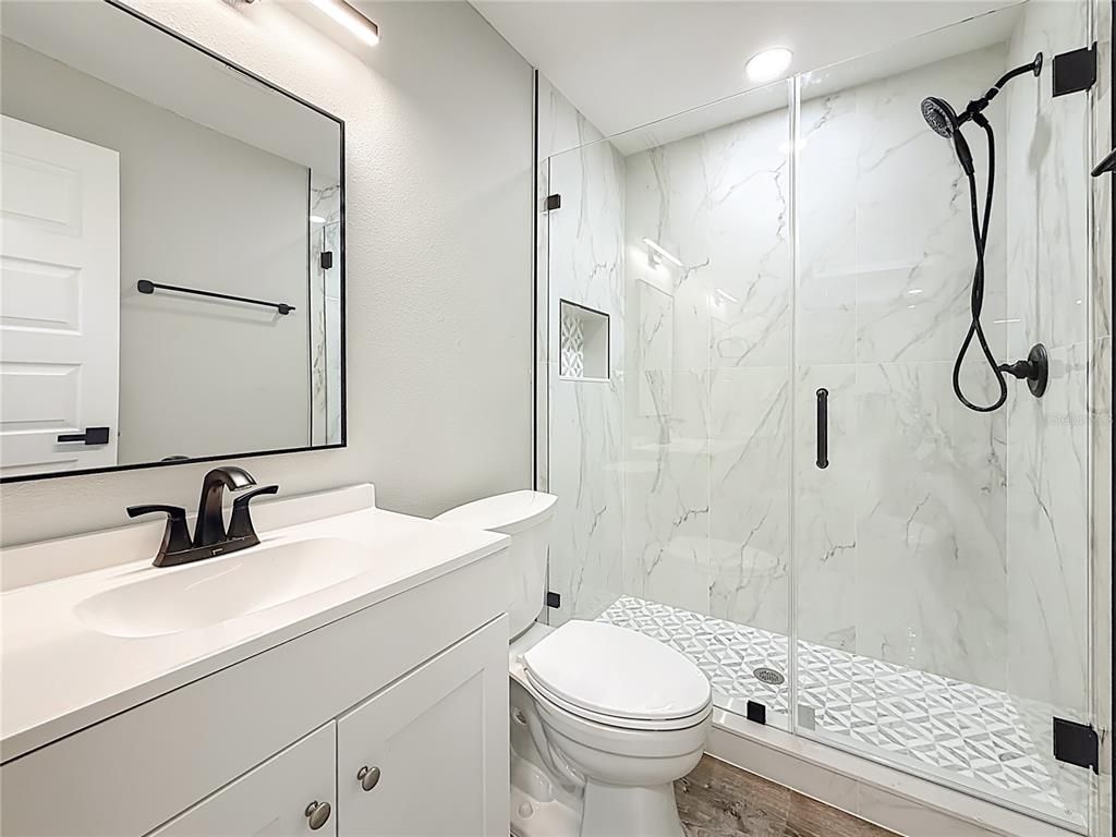 Bathroom, Glass Shower, Interior, Marble Walls, Recessed Lighting, Wood Texture Flooring