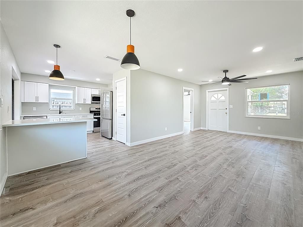 Empty room, Interior, Kitchen, Pendant Lights, Recessed Lighting, Stainless Steel Appliances, Wood Texture Flooring