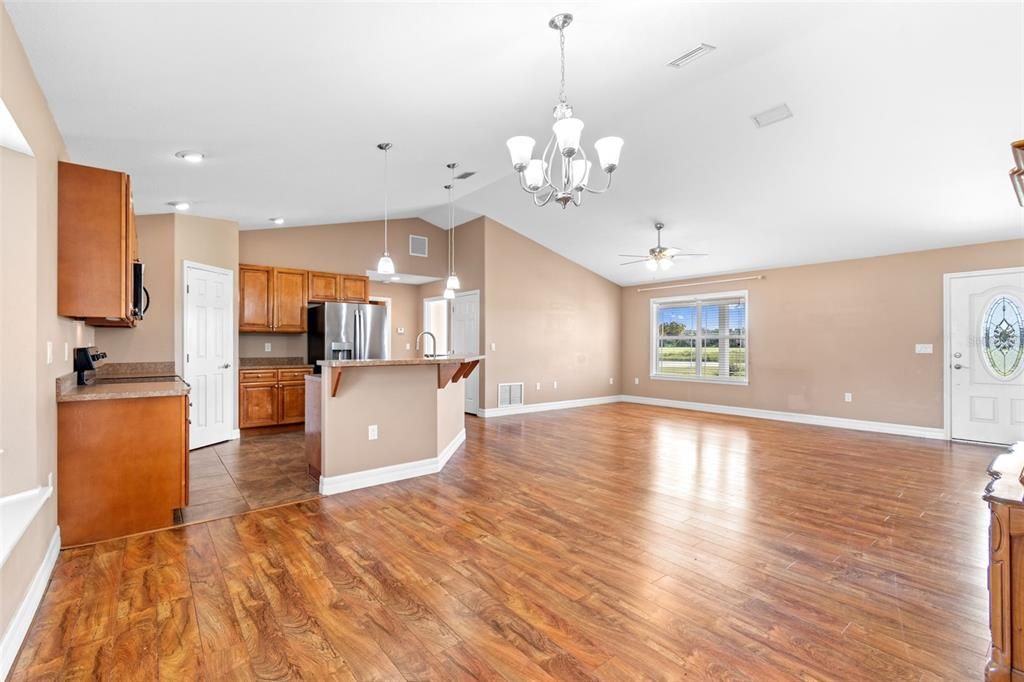 Chandelier, Empty room, Interior, Kitchen, Pendant Lights, Recessed Lighting, Stainless Steel Appliances, Wood Texture Flooring