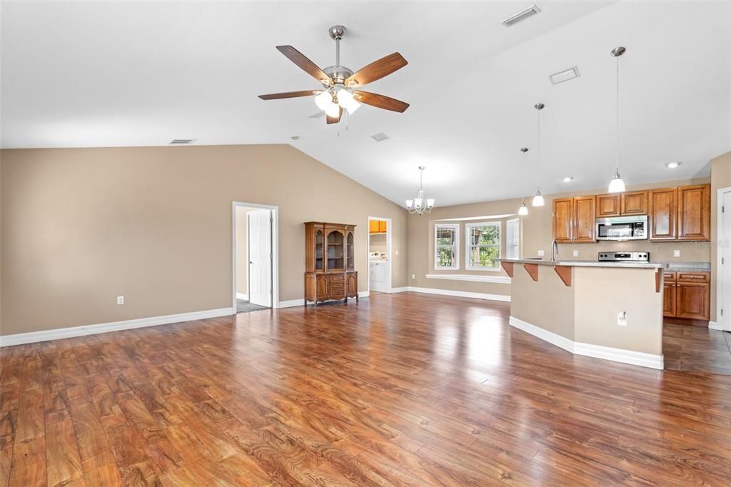 Chandelier, Empty room, Interior, Kitchen, Pendant Lights, Recessed Lighting, Stainless Steel Appliances, Wood Texture Flooring