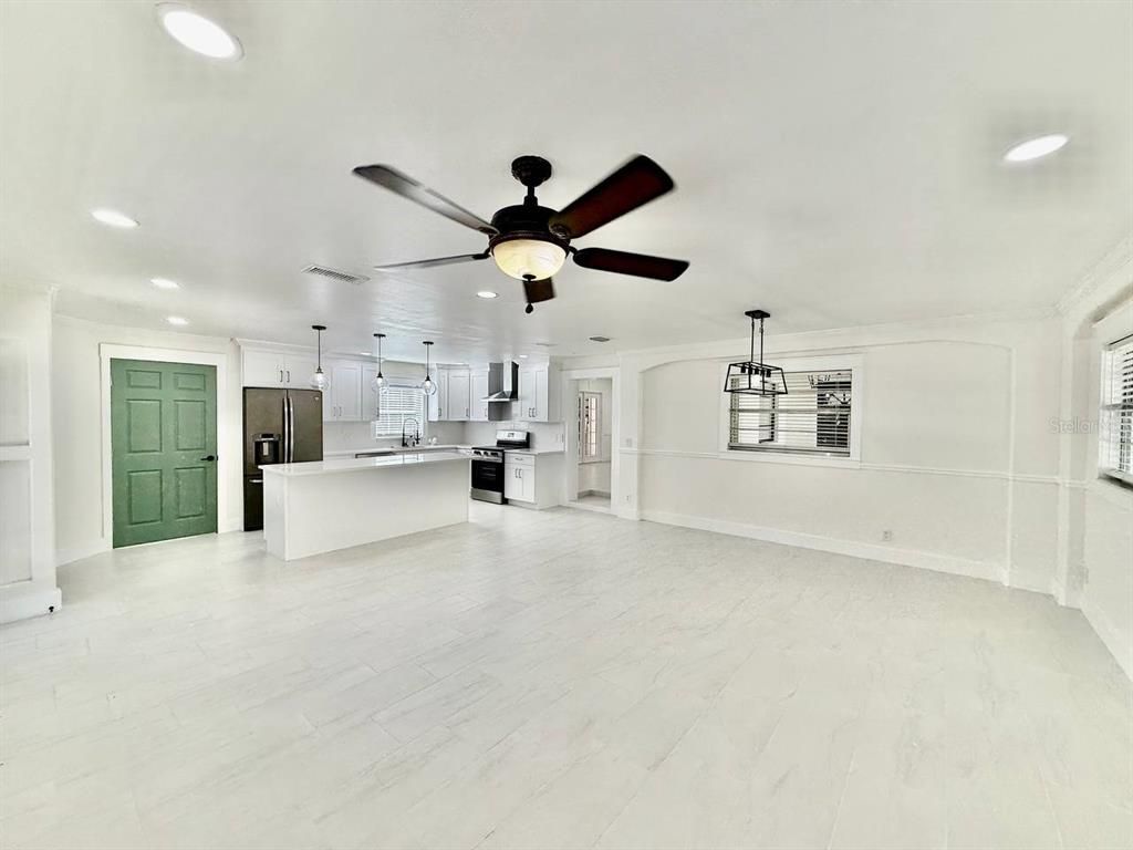 Empty room, Interior, Kitchen, Pendant Lights, Recessed Lighting, Stainless Steel Appliances, Wood Texture Flooring