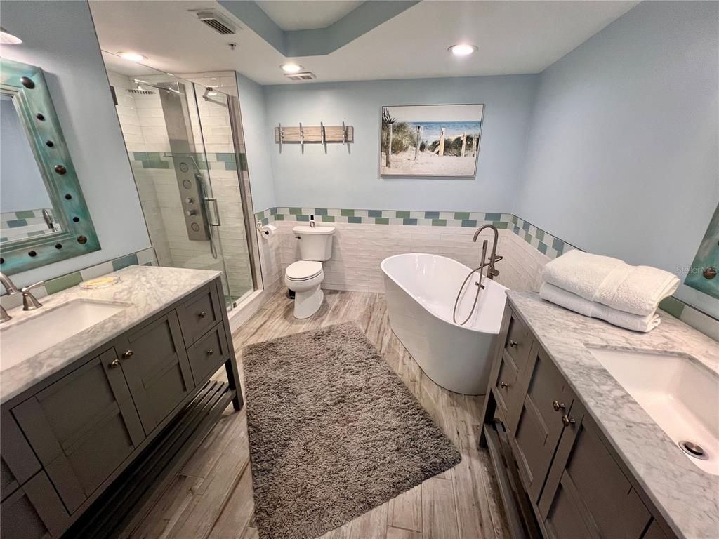 Bathroom, Dual Sink Vanities, Free Standing Baths, Glass Shower, Interior, Recessed Lighting, Wood Texture Flooring