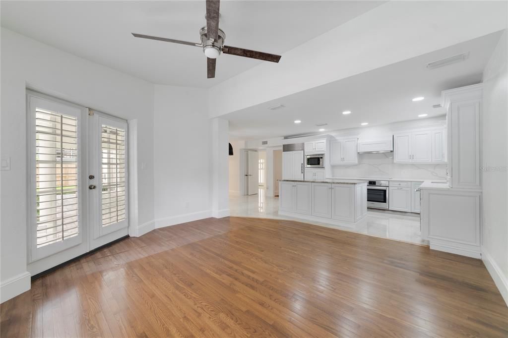 Empty room, Interior, Kitchen, Recessed Lighting, Stainless Steel Appliances, Wood Texture Flooring