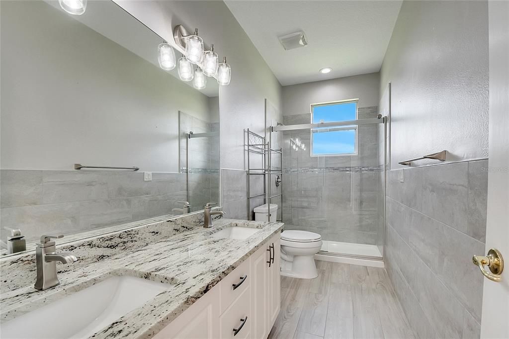Bathroom, Dual Sink Vanities, Glass Shower, Interior, Recessed Lighting, Wood Texture Flooring