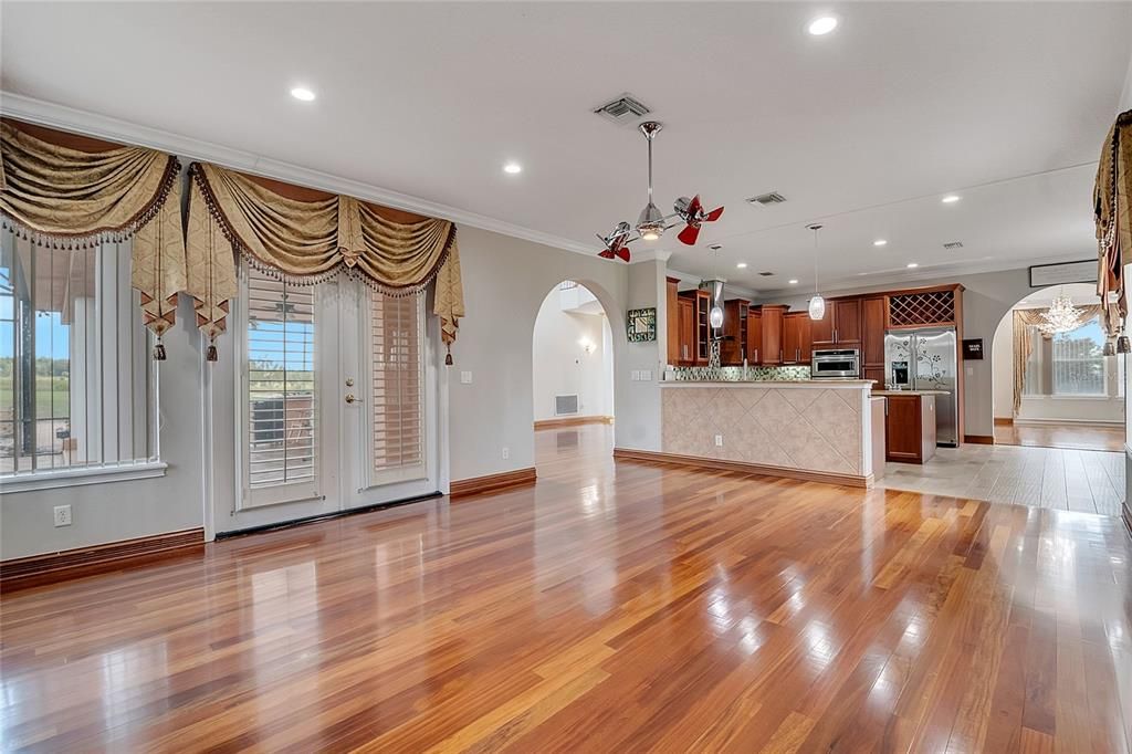Empty room, Interior, Kitchen, Pendant Lights, Recessed Lighting, Stainless Steel Appliances, Wood Texture Flooring