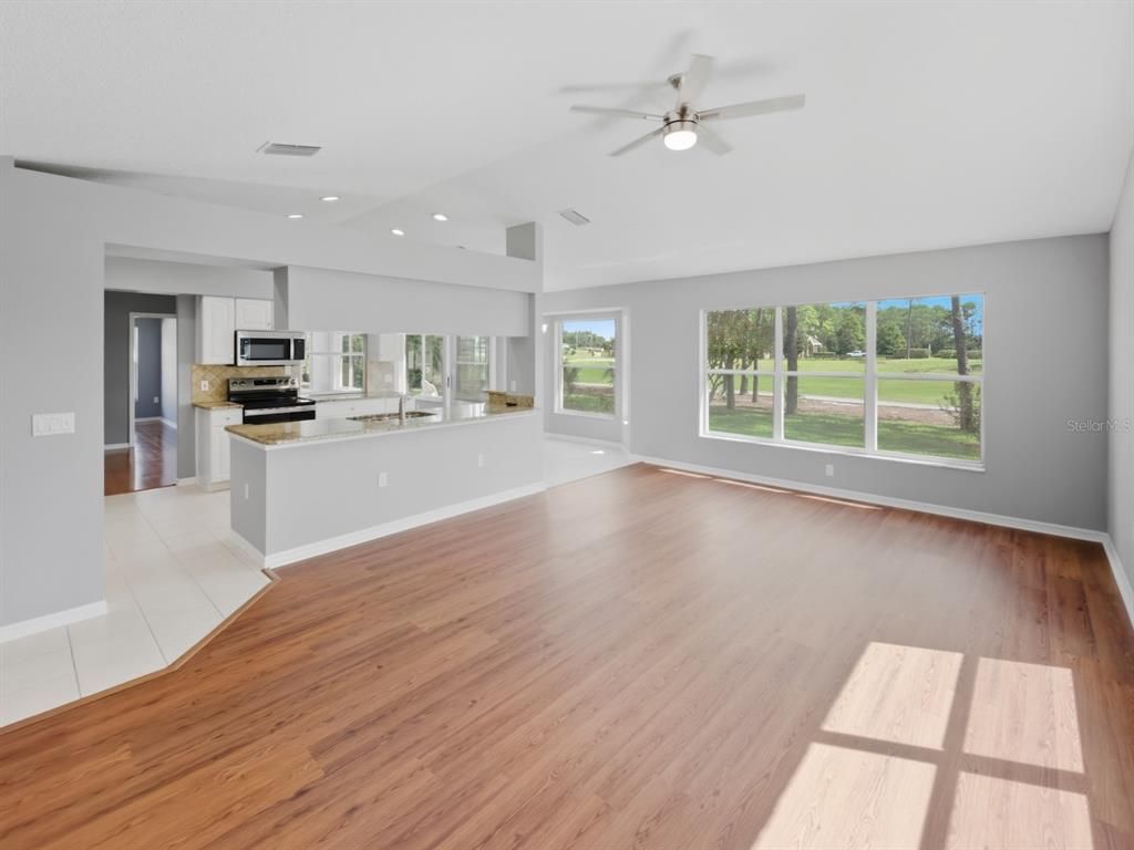 Empty room, Interior, Kitchen, Recessed Lighting, Stainless Steel Appliances, Wood Texture Flooring