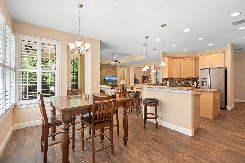 Chandelier, Dining room, Interior, Kitchen, Pendant Lights, Recessed Lighting, Stainless Steel Appliances, Stone Walls, Wood Texture Flooring