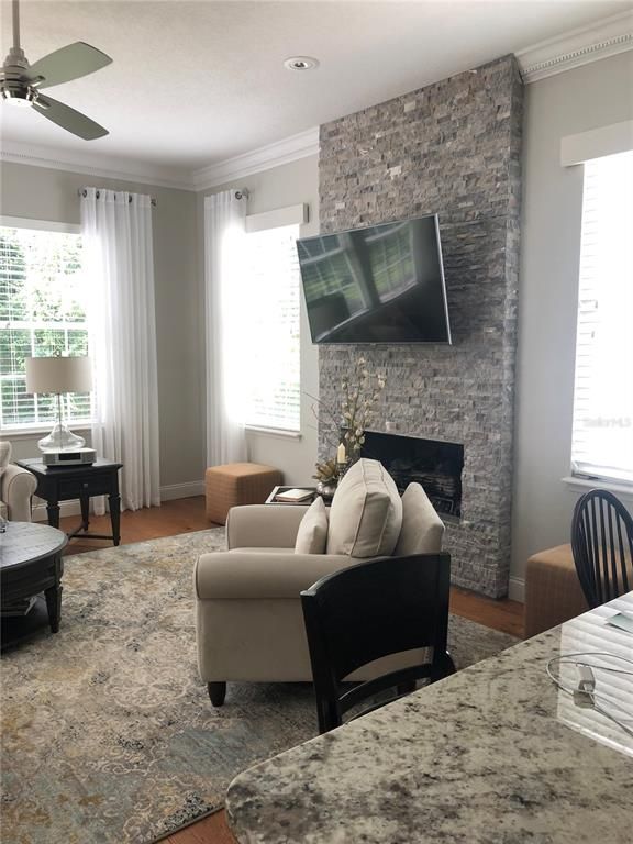 Fireplace, Interior, Living room, Recessed Lighting, Stone Walls, Wood Texture Flooring