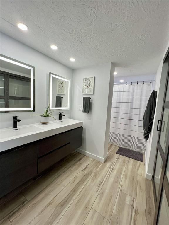 Bathroom, Dual Sink Vanities, Interior, Recessed Lighting, Wood Texture Flooring
