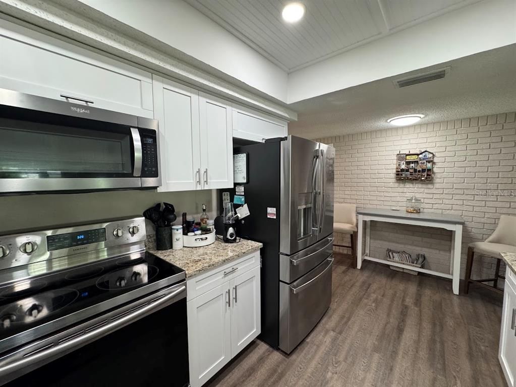 Interior, Kitchen, Recessed Lighting, Stainless Steel Appliances, Stone Walls, Wood Texture Flooring