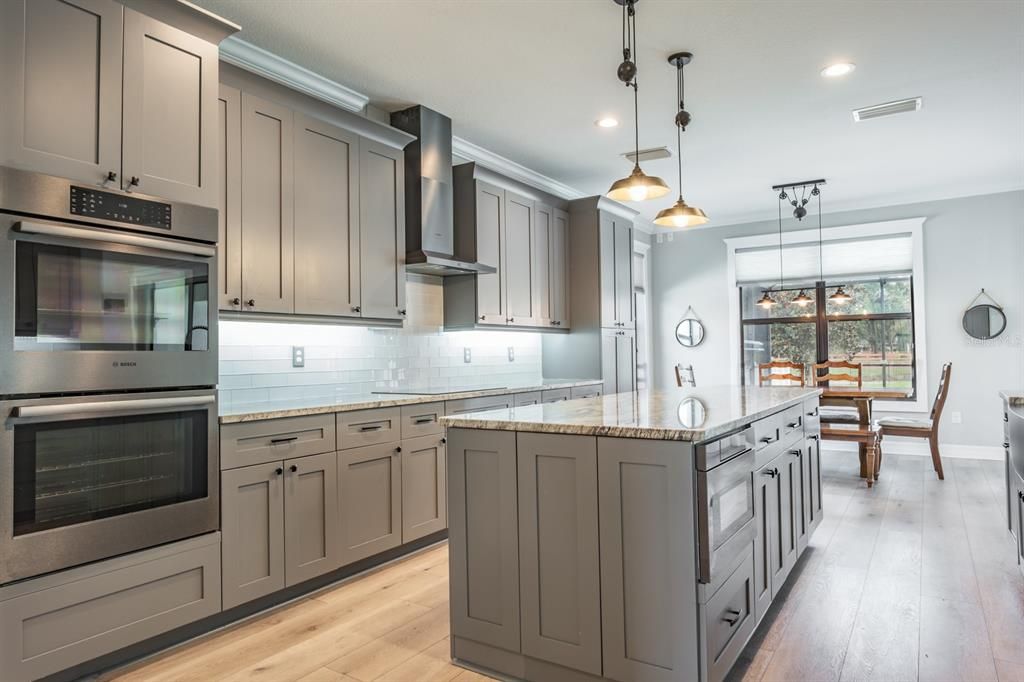 Dining room, Interior, Kitchen, Pendant Lights, Recessed Lighting, Stainless Steel Appliances, Wood Texture Flooring