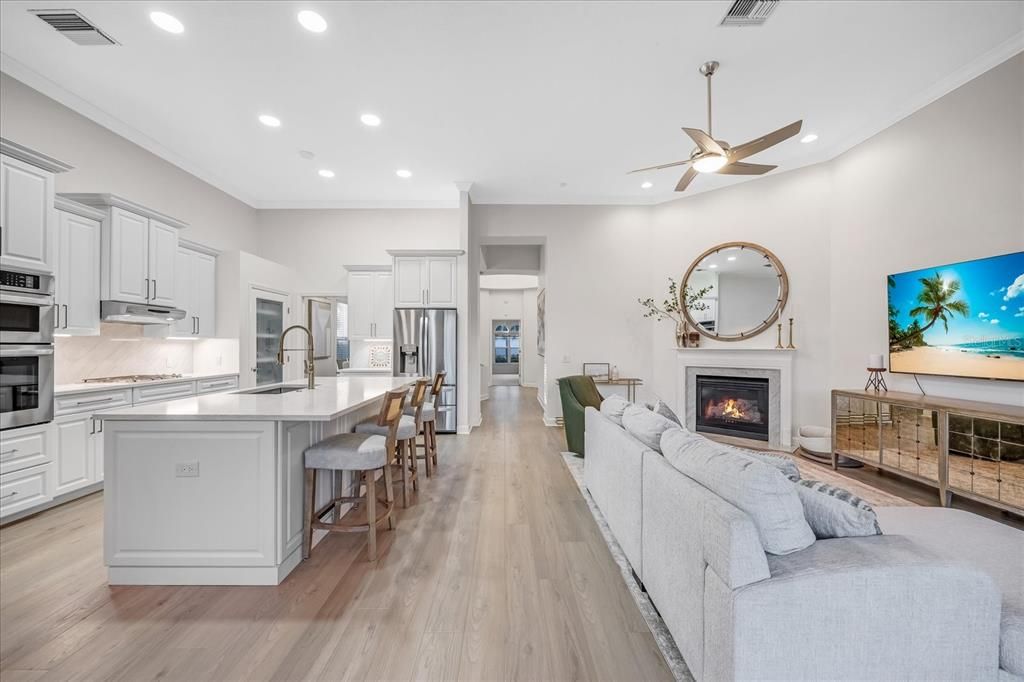 Fireplace, Interior, Kitchen, Living room, Recessed Lighting, Stainless Steel Appliances, Wood Texture Flooring