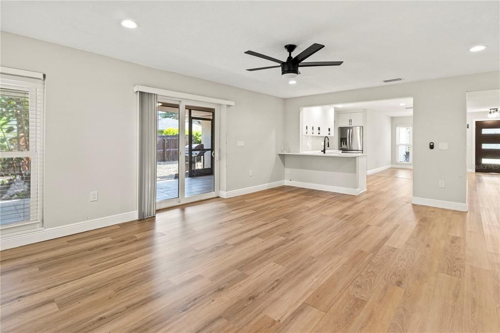 Empty room, Interior, Kitchen, Recessed Lighting, Stainless Steel Appliances, Wood Texture Flooring
