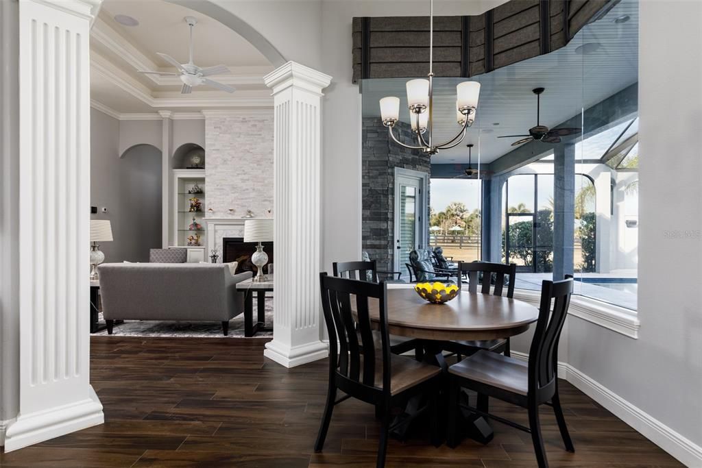 Chandelier, Dining room, Fireplace, Interior, Living room, Pendant Lights, Stone Walls, Wood Texture Flooring