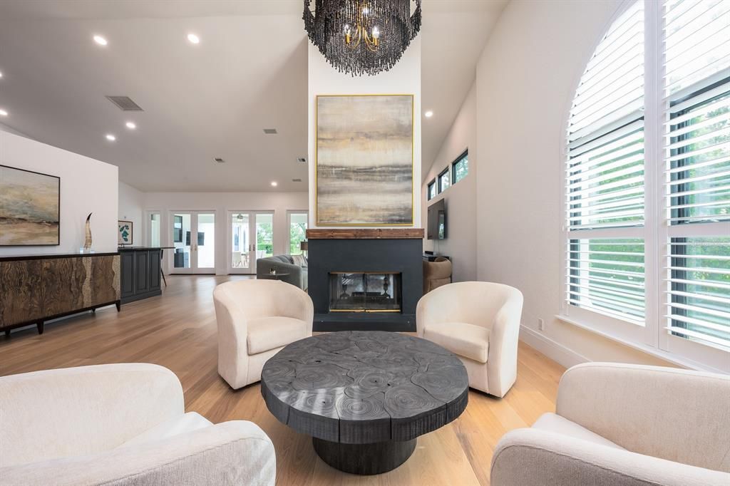 Chandelier, Fireplace, Interior, Living room, Piano, Recessed Lighting, Wood Texture Flooring