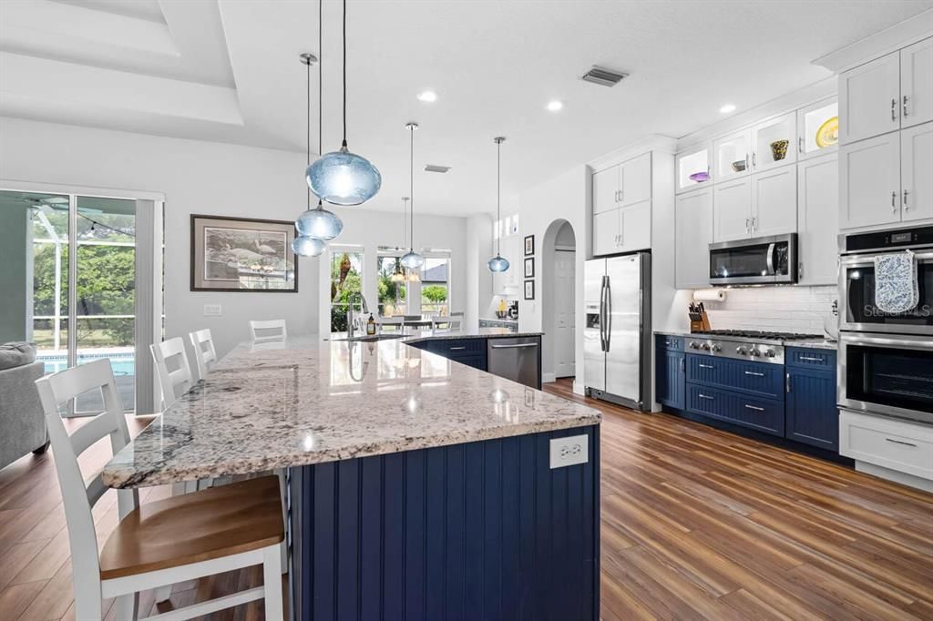 Dining room, Interior, Kitchen, Pendant Lights, Recessed Lighting, Stainless Steel Appliances, Wood Texture Flooring