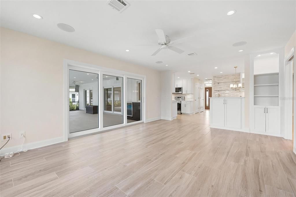 Empty room, Interior, Kitchen, Pendant Lights, Recessed Lighting, Stainless Steel Appliances, Wood Texture Flooring