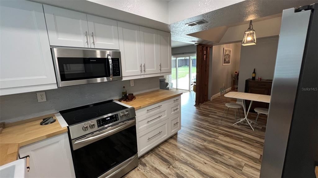 Dining room, Interior, Kitchen, Pendant Lights, Stainless Steel Appliances, Wood Texture Flooring