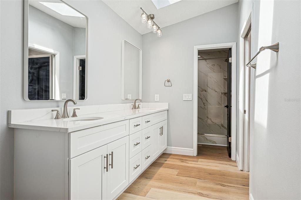 Bathroom, Dual Sink Vanities, Glass Shower, Interior, Marble Walls, Wood Texture Flooring