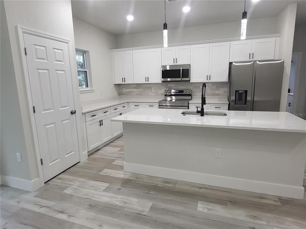 Interior, Kitchen, Pendant Lights, Recessed Lighting, Stainless Steel Appliances, Wood Texture Flooring