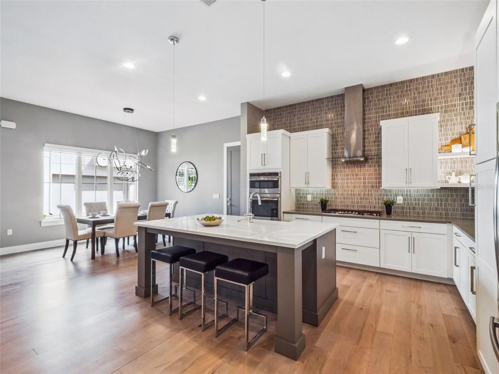 Dining room, Interior, Kitchen, Pendant Lights, Recessed Lighting, Stainless Steel Appliances, Wood Texture Flooring
