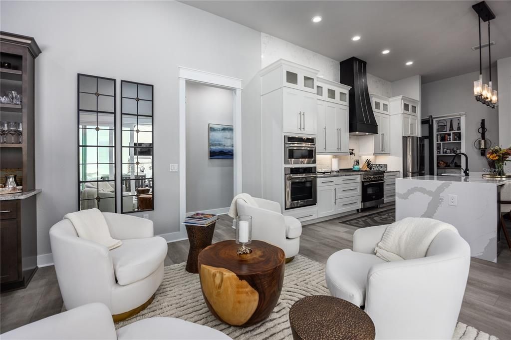 Chandelier, Interior, Kitchen, Living room, Pendant Lights, Recessed Lighting, Stainless Steel Appliances, Wood Texture Flooring
