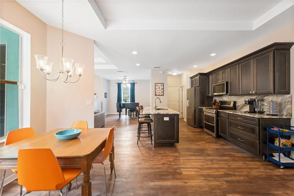 Chandelier, Dining room, Interior, Kitchen, Pendant Lights, Recessed Lighting, Stainless Steel Appliances, Wood Texture Flooring