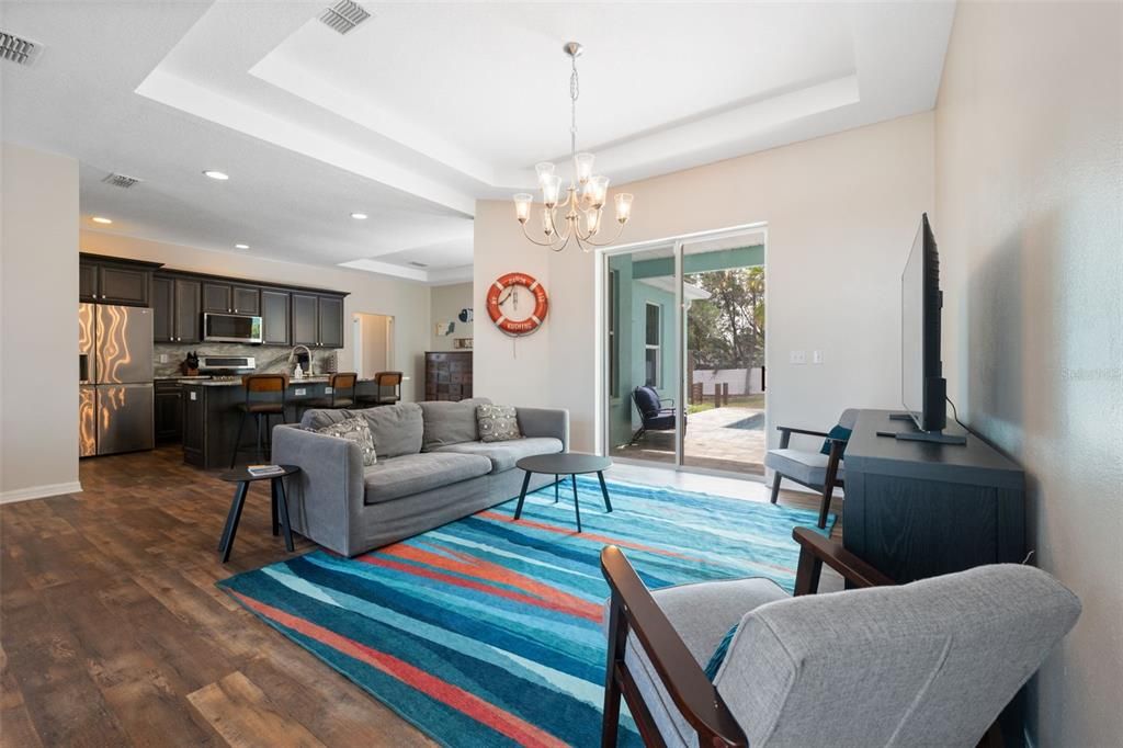 Chandelier, Dining room, Interior, Kitchen, Living room, Recessed Lighting, Stainless Steel Appliances, Wood Texture Flooring