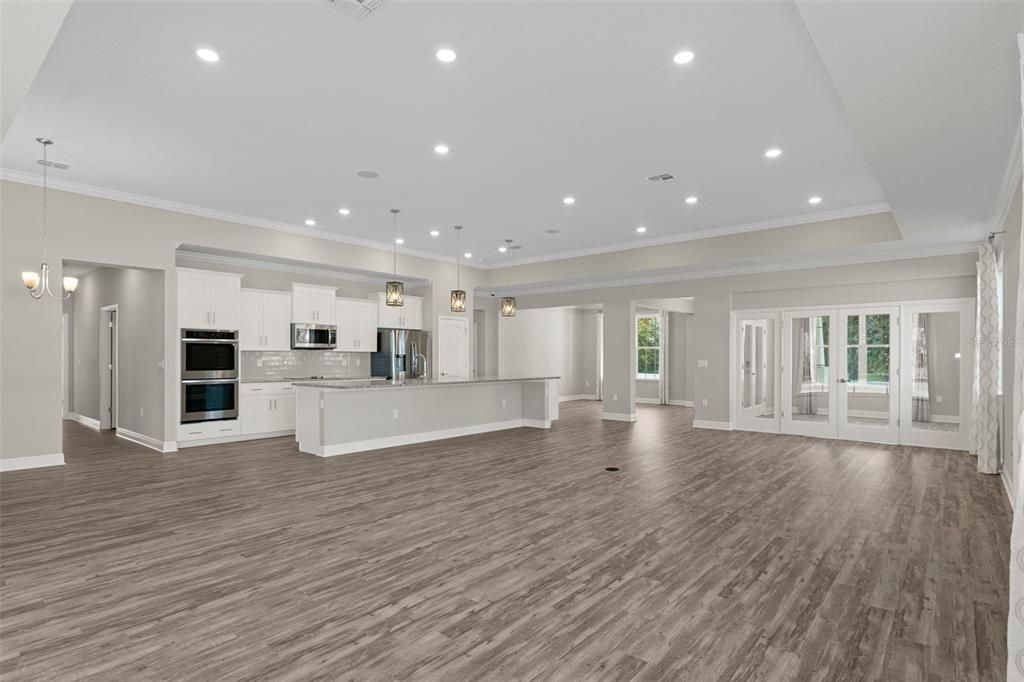 Empty room, Interior, Kitchen, Pendant Lights, Recessed Lighting, Stainless Steel Appliances, Wood Texture Flooring