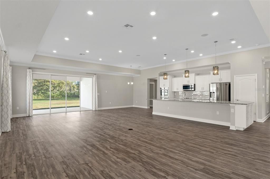 Empty room, Interior, Kitchen, Pendant Lights, Recessed Lighting, Stainless Steel Appliances, Wood Texture Flooring