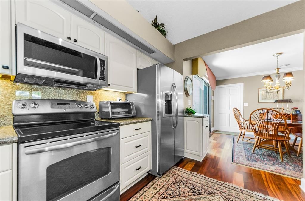 Chandelier, Dining room, Interior, Kitchen, Stainless Steel Appliances, Wood Texture Flooring