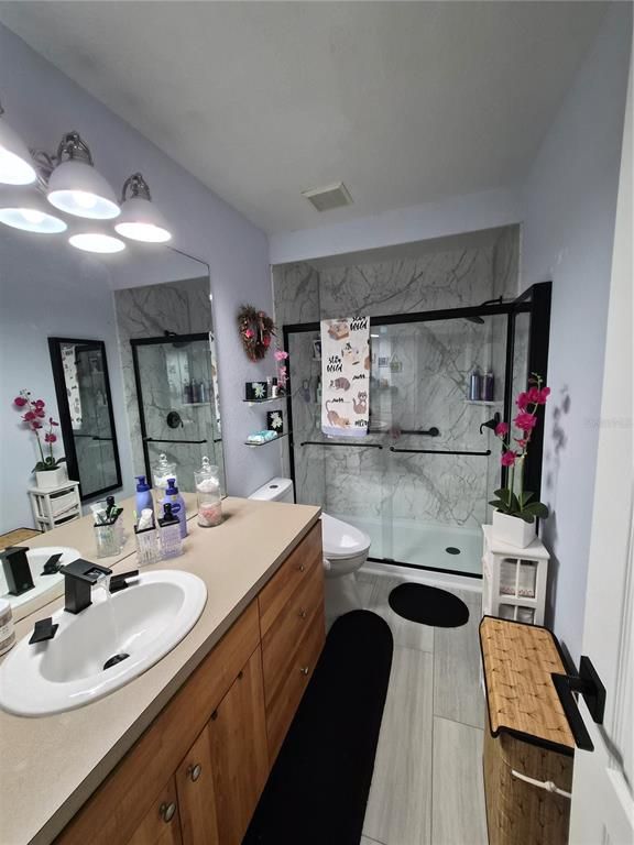 Bathroom, Dual Sink Vanities, Glass Shower, Interior, Marble Walls, Wood Texture Flooring