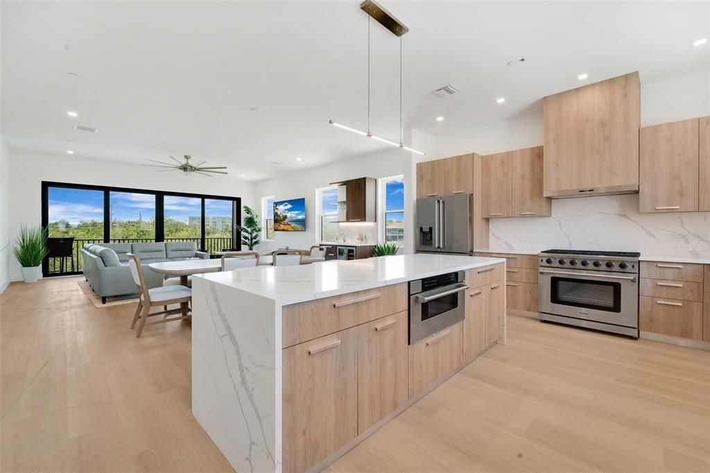 Dining room, Interior, Kitchen, Living room, Pendant Lights, Recessed Lighting, Stainless Steel Appliances, Water, Wood Texture Flooring