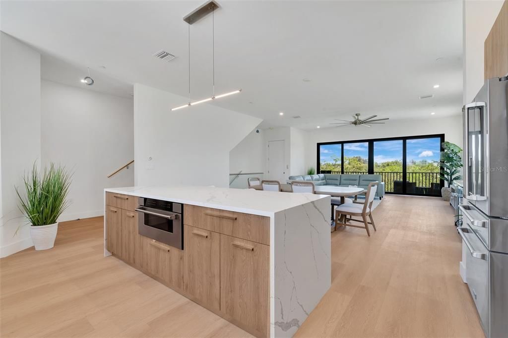 Dining room, Interior, Kitchen, Pendant Lights, Recessed Lighting, Stainless Steel Appliances, Water, Wood Texture Flooring