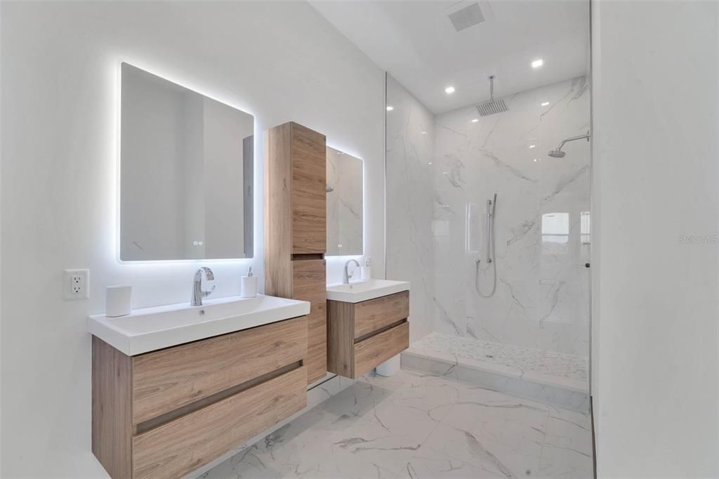 Bathroom, Dual Sink Vanities, Glass Shower, Interior, Marble, Marble Walls, Recessed Lighting